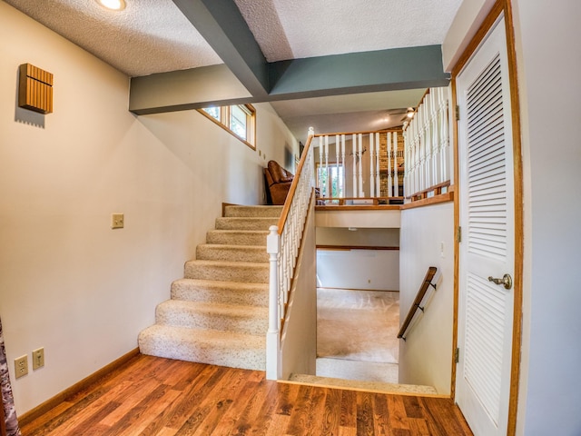 300 27th St NE, Bemidji, MN 56601 - staircase with a textured ceiling, wood finished floors, and baseboards