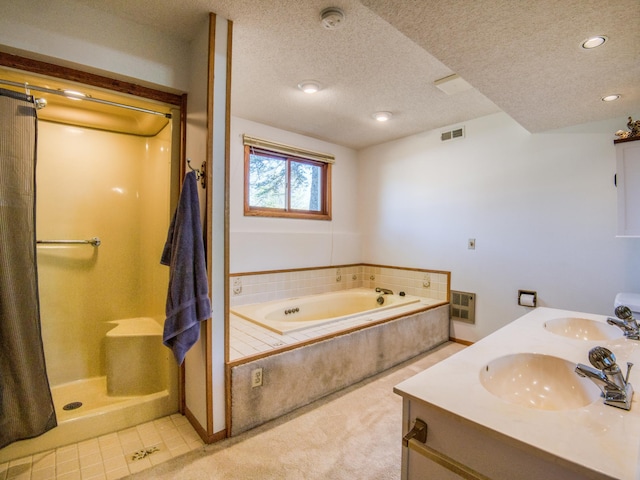 300 27th St NE, Bemidji, MN 56601 - bathroom featuring a bath, a textured ceiling, double vanity, recessed lighting, and a shower