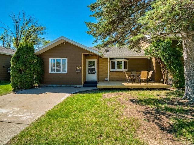 300 27th St NE, Bemidji, MN 56601 - view of front of home with a front yard, a deck, and outdoor dining area