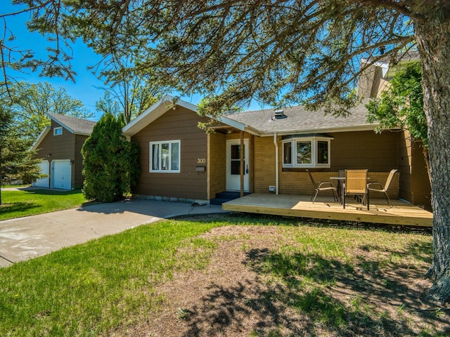 300 27th St NE, Bemidji, MN 56601 - view of front facade with a front yard, a deck, a chimney, and a shingled roof