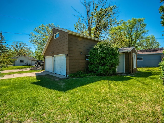 300 27th St NE, Bemidji, MN 56601 - view of property exterior featuring a detached garage and a yard