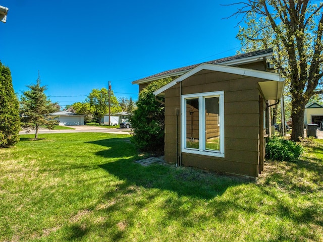 300 27th St NE, Bemidji, MN 56601 - view of home's exterior featuring a yard and an outdoor structure
