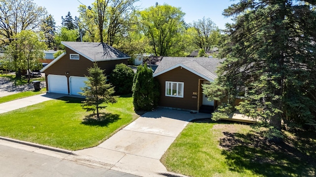 300 27th St NE, Bemidji, MN 56601 - view of front of property featuring a front yard, concrete driveway, roof with shingles, and a garage