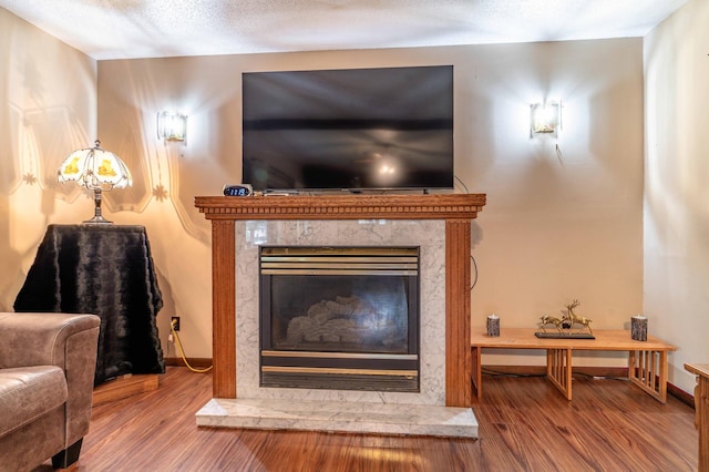 504 Laurel St, Fergus Falls, MN 56537 - detailed view of wood finished floors, a high end fireplace, and a textured ceiling