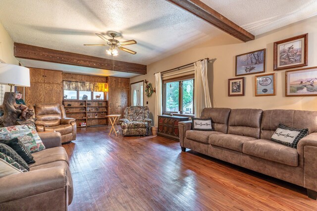 504 Laurel St, Fergus Falls, MN 56537 - living area with beamed ceiling, a textured ceiling, wood finished floors, ceiling fan, and healthy amount of natural light
