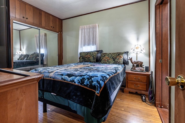 504 Laurel St, Fergus Falls, MN 56537 - bedroom with light wood finished floors, crown molding, and a closet