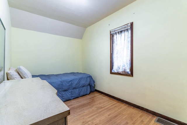 504 Laurel St, Fergus Falls, MN 56537 - bedroom with vaulted ceiling and light wood-style flooring