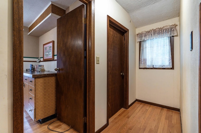 504 Laurel St, Fergus Falls, MN 56537 - hallway featuring a textured ceiling and light wood finished floors