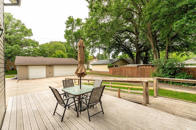 504 Laurel St, Fergus Falls, MN 56537 - deck with a garage, an outdoor structure, and outdoor dining space