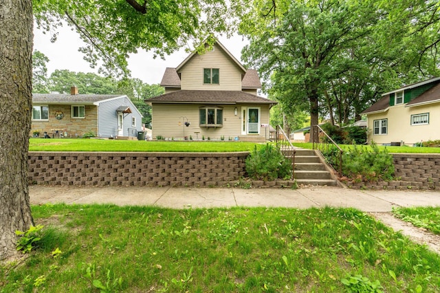 504 Laurel St, Fergus Falls, MN 56537 - view of front of house with a front yard and a shingled roof