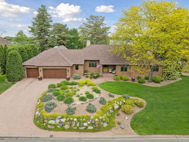 21273 Floral Bay Dr N, Forest Lake, MN 55025 - view of front facade featuring an attached garage, driveway, a front lawn, brick siding, and a chimney