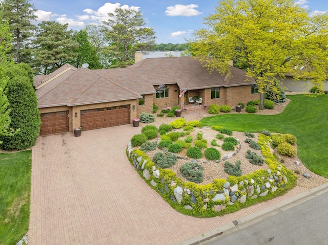 21273 Floral Bay Dr N, Forest Lake, MN 55025 - view of front facade featuring an attached garage, decorative driveway, a front yard, and brick siding