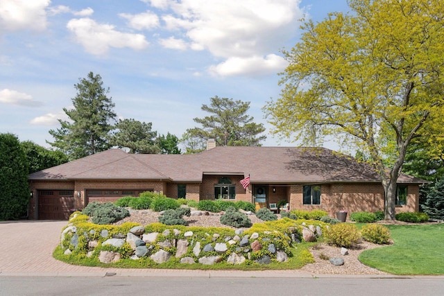 21273 Floral Bay Dr N, Forest Lake, MN 55025 - view of front of house featuring an attached garage, decorative driveway, brick siding, and a chimney