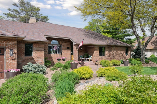 21273 Floral Bay Dr N, Forest Lake, MN 55025 - view of front of property featuring brick siding, a chimney, and a patio area