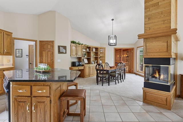 21273 Floral Bay Dr N, Forest Lake, MN 55025 - kitchen featuring light colored carpet, open shelves, a kitchen island, a multi sided fireplace, and light tile patterned flooring