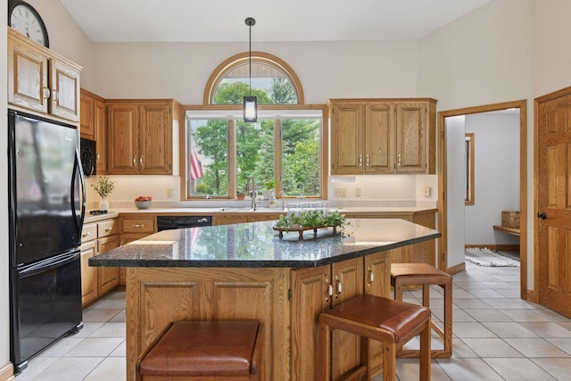 21273 Floral Bay Dr N, Forest Lake, MN 55025 - kitchen featuring black appliances, a breakfast bar area, decorative backsplash, and light tile patterned flooring
