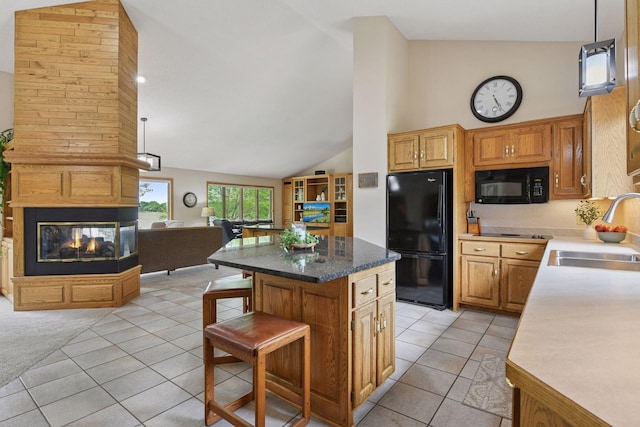 21273 Floral Bay Dr N, Forest Lake, MN 55025 - kitchen with black appliances, open floor plan, light tile patterned floors, a center island, and a breakfast bar area