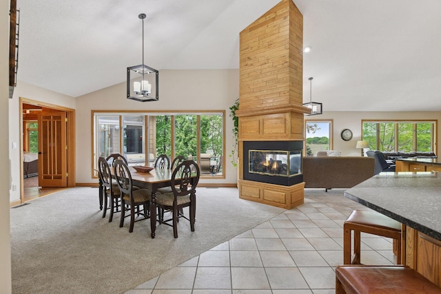 21273 Floral Bay Dr N, Forest Lake, MN 55025 - dining room featuring a multi sided fireplace, light colored carpet, a chandelier, high vaulted ceiling, and light tile patterned floors