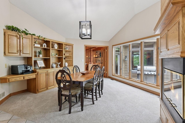 21273 Floral Bay Dr N, Forest Lake, MN 55025 - dining room featuring lofted ceiling, light colored carpet, and built in desk