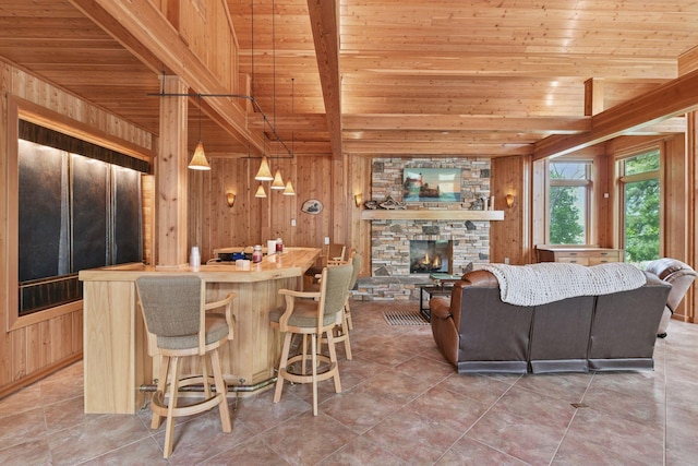 21273 Floral Bay Dr N, Forest Lake, MN 55025 - kitchen featuring a wooden ceiling with exposed beams, wood walls, a stone fireplace, a kitchen island, and open floor plan