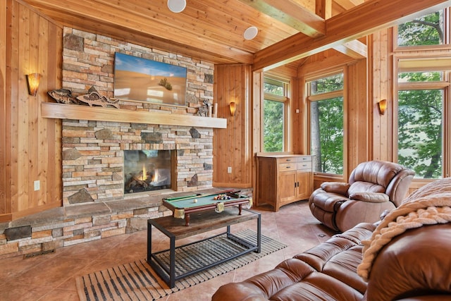21273 Floral Bay Dr N, Forest Lake, MN 55025 - living area with wood walls, a wood ceiling with exposed beams, billiards, tile patterned floors, and a stone fireplace