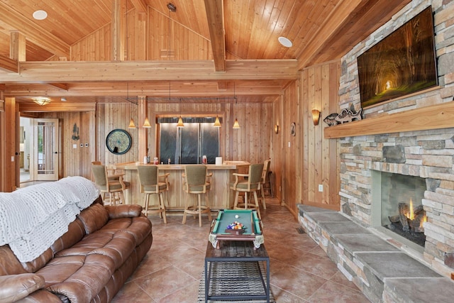 21273 Floral Bay Dr N, Forest Lake, MN 55025 - tiled living area featuring wood walls, a bar, a stone fireplace, and wood ceiling