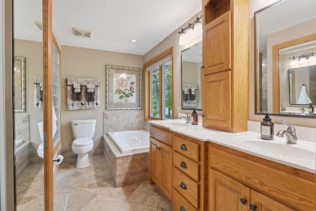 21273 Floral Bay Dr N, Forest Lake, MN 55025 - bathroom with a relaxing tiled tub, double vanity, and a textured ceiling
