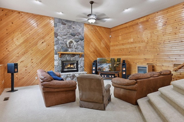 21273 Floral Bay Dr N, Forest Lake, MN 55025 - living room featuring wooden walls, a ceiling fan, stairway, a fireplace, and carpet