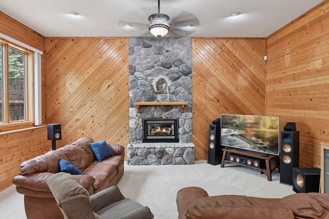 21273 Floral Bay Dr N, Forest Lake, MN 55025 - carpeted living room featuring ceiling fan, a fireplace, and wooden walls