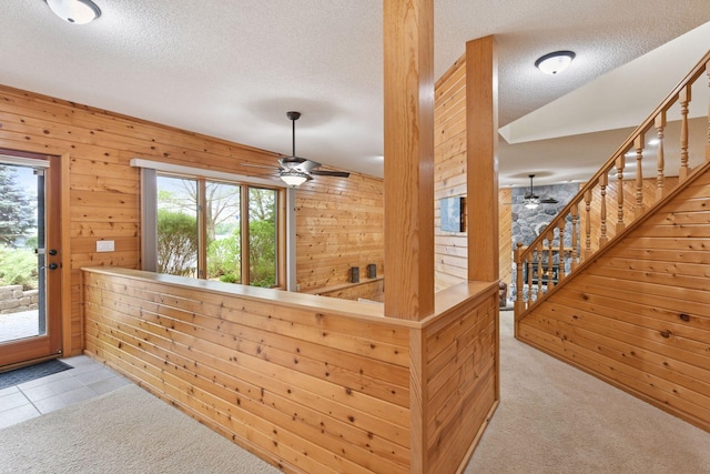 21273 Floral Bay Dr N, Forest Lake, MN 55025 - entrance foyer with ceiling fan, wood walls, a textured ceiling, carpet, and stairs