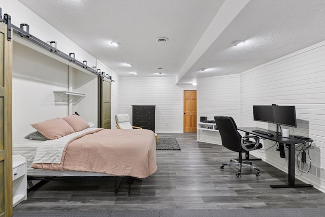 21273 Floral Bay Dr N, Forest Lake, MN 55025 - bedroom featuring a barn door, dark wood-style flooring, and an office area