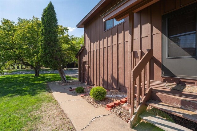 6900 Unity Ave N, Brooklyn Center, MN 55429 - view of property exterior with board and batten siding and a yard