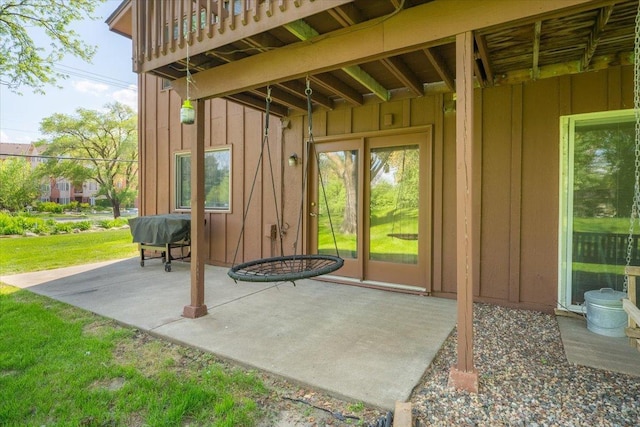 6900 Unity Ave N, Brooklyn Center, MN 55429 - doorway to property featuring board and batten siding, a patio area, and a yard