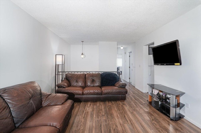 6900 Unity Ave N, Brooklyn Center, MN 55429 - living area featuring wood finished floors, a textured ceiling, and baseboards