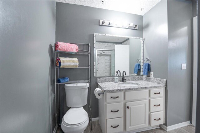 6900 Unity Ave N, Brooklyn Center, MN 55429 - bathroom with a stall shower, toilet, vanity, and baseboards