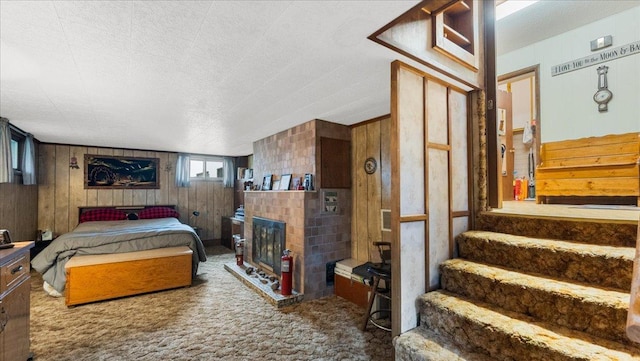 19157 181st Ave, Long Prairie, MN 56347 - carpeted bedroom with wood walls and a fireplace