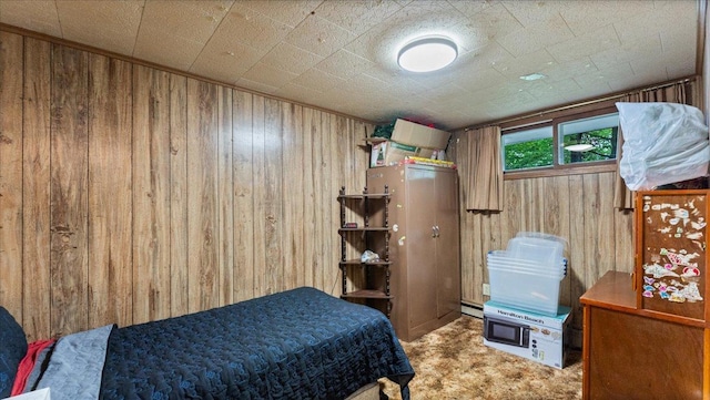19157 181st Ave, Long Prairie, MN 56347 - bedroom with wood walls, carpet floors, and a baseboard heating unit