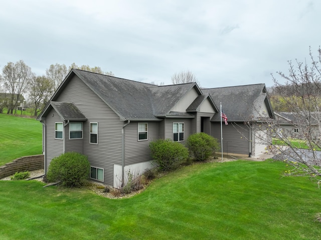 N5024 558th St, Menomonie, WI 54751 - view of front of property featuring a shingled roof, a front yard, and a garage