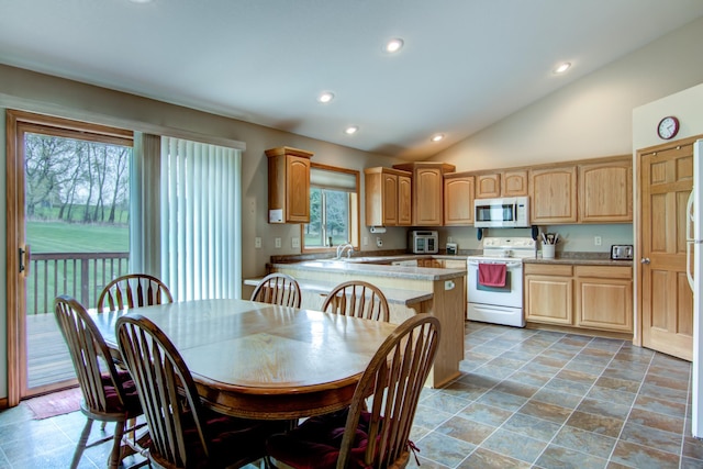 N5024 558th St, Menomonie, WI 54751 - kitchen featuring white appliances, vaulted ceiling, light brown cabinets, recessed lighting, and light countertops