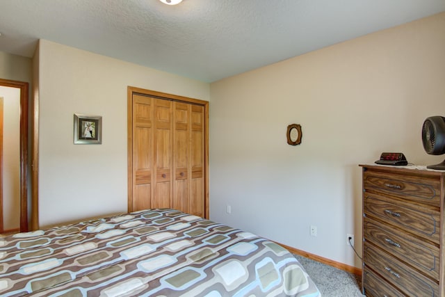 N5024 558th St, Menomonie, WI 54751 - bedroom featuring a closet, carpet, a textured ceiling, and baseboards