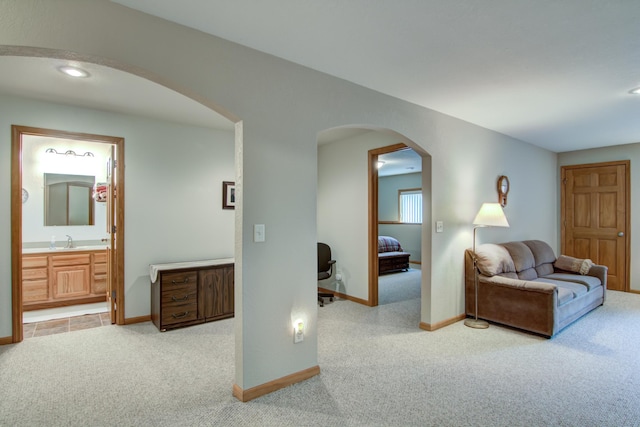 N5024 558th St, Menomonie, WI 54751 - carpeted living area with arched walkways, baseboards, recessed lighting, and a sink