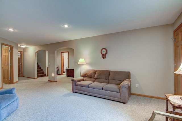 N5024 558th St, Menomonie, WI 54751 - living area featuring arched walkways, light carpet, baseboards, recessed lighting, and stairway