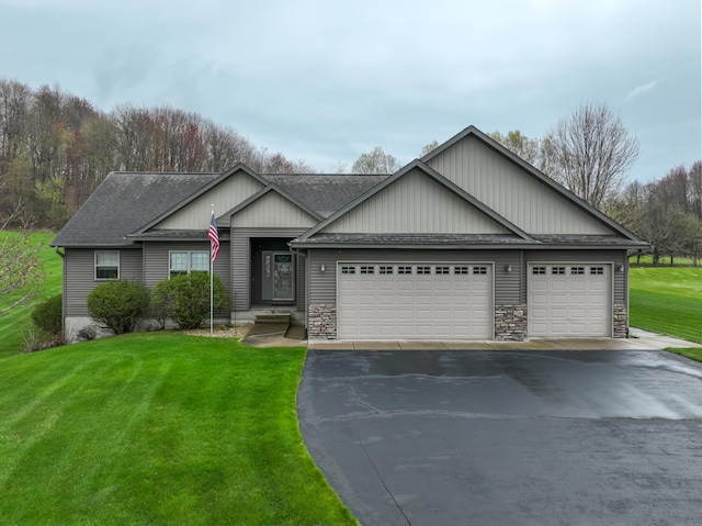 N5024 558th St, Menomonie, WI 54751 - view of front of property featuring driveway, a shingled roof, a garage, and a front yard