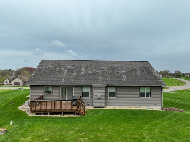 N5024 558th St, Menomonie, WI 54751 - rear view of house featuring a wooden deck, a lawn, and a shingled roof