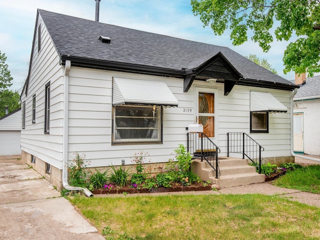 2159 Nortonia Ave, Saint Paul, MN 55119 - view of front of house with a shingled roof, an outdoor structure, and a front lawn