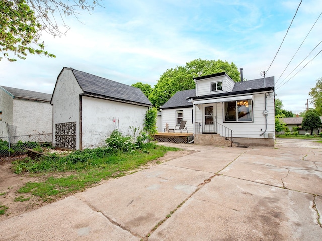 2159 Nortonia Ave, Saint Paul, MN 55119 - back of house with fence, an outdoor structure, and concrete driveway