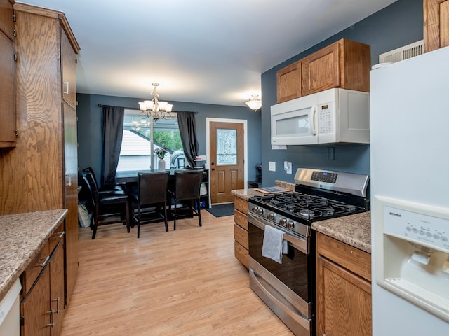 2159 Nortonia Ave, Saint Paul, MN 55119 - kitchen featuring white appliances, a chandelier, light wood finished floors, brown cabinetry, and decorative light fixtures
