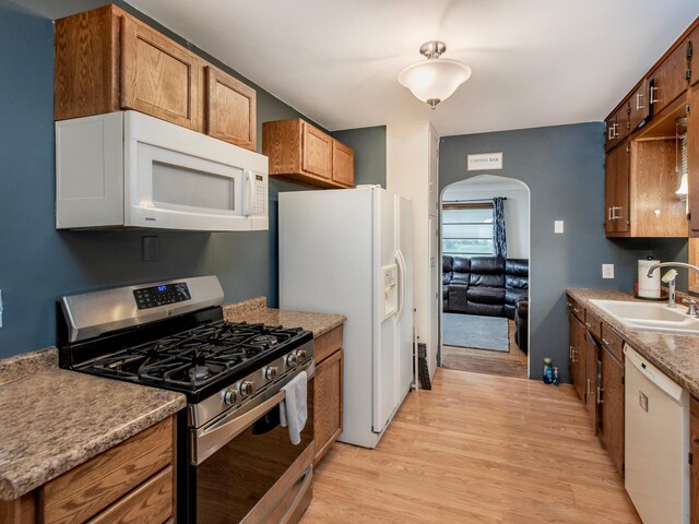 2159 Nortonia Ave, Saint Paul, MN 55119 - kitchen featuring white appliances, a sink, arched walkways, and light wood-style flooring
