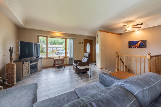 living area featuring light wood finished floors and a ceiling fan