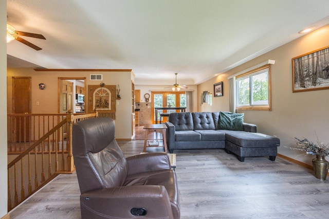 living room with ceiling fan, healthy amount of natural light, and wood finished floors